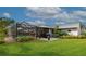 Landscaped backyard with pool, patio, and lush greenery at 2154 Lakewood Dr, Nokomis, FL 34275