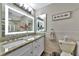 Updated bathroom with granite countertops and a walk-in shower at 2154 Lakewood Dr, Nokomis, FL 34275