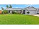 Well-maintained single story home with a spacious lawn and attached garage at 2154 Lakewood Dr, Nokomis, FL 34275