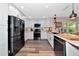 Modern kitchen with stainless steel appliances and white cabinets at 2154 Lakewood Dr, Nokomis, FL 34275