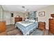 Large main bedroom with a king bed and wood furniture at 2154 Lakewood Dr, Nokomis, FL 34275