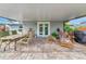 Relaxing patio with seating, dining area, and lush landscaping at 2154 Lakewood Dr, Nokomis, FL 34275