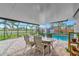 Inviting pool area with patio furniture and screened enclosure at 2154 Lakewood Dr, Nokomis, FL 34275