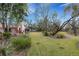 Large grassy backyard with mature trees and landscaping at 2218 Shadow Oaks Rd, Sarasota, FL 34240