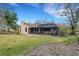Expansive backyard with a well-manicured lawn, screened lanai and mature trees offering privacy at 2218 Shadow Oaks Rd, Sarasota, FL 34240