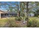 Landscaped backyard with a garden and shed at 2218 Shadow Oaks Rd, Sarasota, FL 34240