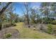 Landscaped backyard with a winding path and lush vegetation at 2218 Shadow Oaks Rd, Sarasota, FL 34240