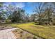 Large backyard with lush landscaping and a spacious lawn at 2218 Shadow Oaks Rd, Sarasota, FL 34240