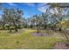 Expansive backyard with lush landscaping and mature trees at 2218 Shadow Oaks Rd, Sarasota, FL 34240