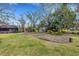 Large backyard with garden and screened patio at 2218 Shadow Oaks Rd, Sarasota, FL 34240