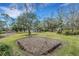 Landscaped backyard with garden beds and pond view at 2218 Shadow Oaks Rd, Sarasota, FL 34240