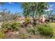 Lush backyard landscaping with mature trees, colorful plants, and a serene atmosphere at 2218 Shadow Oaks Rd, Sarasota, FL 34240