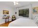 Serene bedroom with hardwood floors, large window and a ceiling fan at 2218 Shadow Oaks Rd, Sarasota, FL 34240