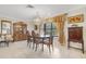 Formal dining room with wooden table, chandelier, and views to the backyard at 2218 Shadow Oaks Rd, Sarasota, FL 34240