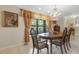 Bright dining room with a wooden table and chairs, and a large window at 2218 Shadow Oaks Rd, Sarasota, FL 34240