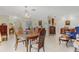 Sunlit dining room showcasing a wooden table, chairs, and a crystal chandelier at 2218 Shadow Oaks Rd, Sarasota, FL 34240