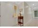 Entryway features a decorative glass window by the front door and a charming side table with flower arrangement at 2218 Shadow Oaks Rd, Sarasota, FL 34240
