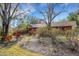 Beautiful front yard featuring mature trees and colorful landscaping that enhances the curb appeal at 2218 Shadow Oaks Rd, Sarasota, FL 34240