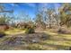 House nestled among mature trees and beautifully landscaped grounds at 2218 Shadow Oaks Rd, Sarasota, FL 34240
