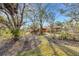 A well-manicured lawn with lush landscaping and mature trees surrounds the house at 2218 Shadow Oaks Rd, Sarasota, FL 34240