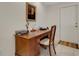 Functional home office featuring a wooden desk, chair, and framed artwork at 2218 Shadow Oaks Rd, Sarasota, FL 34240