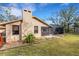 Tan house exterior with a large backyard and trees at 2218 Shadow Oaks Rd, Sarasota, FL 34240
