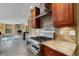 Modern kitchen with stainless steel appliances, a granite countertop, and dark wood cabinets at 2218 Shadow Oaks Rd, Sarasota, FL 34240