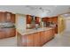 Open-concept kitchen with an island, stainless steel appliances, and a view of the cozy living room at 2218 Shadow Oaks Rd, Sarasota, FL 34240