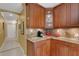 Corner kitchen with granite countertops and wood cabinets at 2218 Shadow Oaks Rd, Sarasota, FL 34240