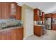 Kitchen boasts ample wood cabinetry, granite counters, and a built-in glass-front cabinet at 2218 Shadow Oaks Rd, Sarasota, FL 34240