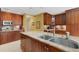 Well-appointed kitchen featuring a center island, modern appliances, granite counters, and ample cabinet space at 2218 Shadow Oaks Rd, Sarasota, FL 34240