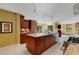 Open kitchen with large island, granite countertops, and custom cabinetry at 2218 Shadow Oaks Rd, Sarasota, FL 34240