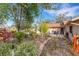Landscaped backyard with stone pathway and lush greenery at 2218 Shadow Oaks Rd, Sarasota, FL 34240