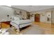 Spacious bedroom featuring light wood floors, a skylight, and tasteful decor at 2218 Shadow Oaks Rd, Sarasota, FL 34240