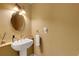 Stylish powder room features decorative sink and classic finishes at 2218 Shadow Oaks Rd, Sarasota, FL 34240