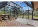 Relaxing screened patio with a waterfall feature and wood deck at 2218 Shadow Oaks Rd, Sarasota, FL 34240