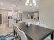 Open concept dining room with dark wood table and view of kitchen at 2692 Mctague St, North Port, FL 34291