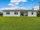 House with solar panels and grassy backyard at 2692 Mctague St, North Port, FL 34291
