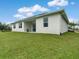 White house with backyard patio and green lawn at 2692 Mctague St, North Port, FL 34291