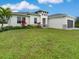 Modern house with landscaped lawn and driveway at 2692 Mctague St, North Port, FL 34291