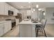 Open concept kitchen with island seating and stainless steel appliances at 2692 Mctague St, North Port, FL 34291