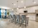Modern kitchen with white cabinets, breakfast bar, and dining area at 2692 Mctague St, North Port, FL 34291