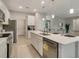 Island kitchen features white cabinets, quartz countertops, and stainless steel appliances at 2692 Mctague St, North Port, FL 34291