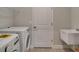 Bright laundry room with washer, dryer, and utility sink at 2692 Mctague St, North Port, FL 34291