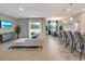 Open concept living area with sectional sofa and kitchen at 2692 Mctague St, North Port, FL 34291