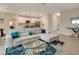 Open concept living room with sectional sofa and kitchen access at 2692 Mctague St, North Port, FL 34291