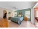 Main bedroom with a king-size bed and access to the bathroom at 2808 68Th Street W Cir, Bradenton, FL 34209