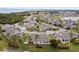 Aerial view of a community with numerous houses and a pond at 2906 Captains Ct, Palmetto, FL 34221