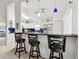 Kitchen boasts a breakfast bar with three stools and modern appliances at 2906 Captains Ct, Palmetto, FL 34221