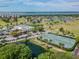 Aerial view of tennis courts near clubhouse and golf course at 2906 Captains Ct, Palmetto, FL 34221